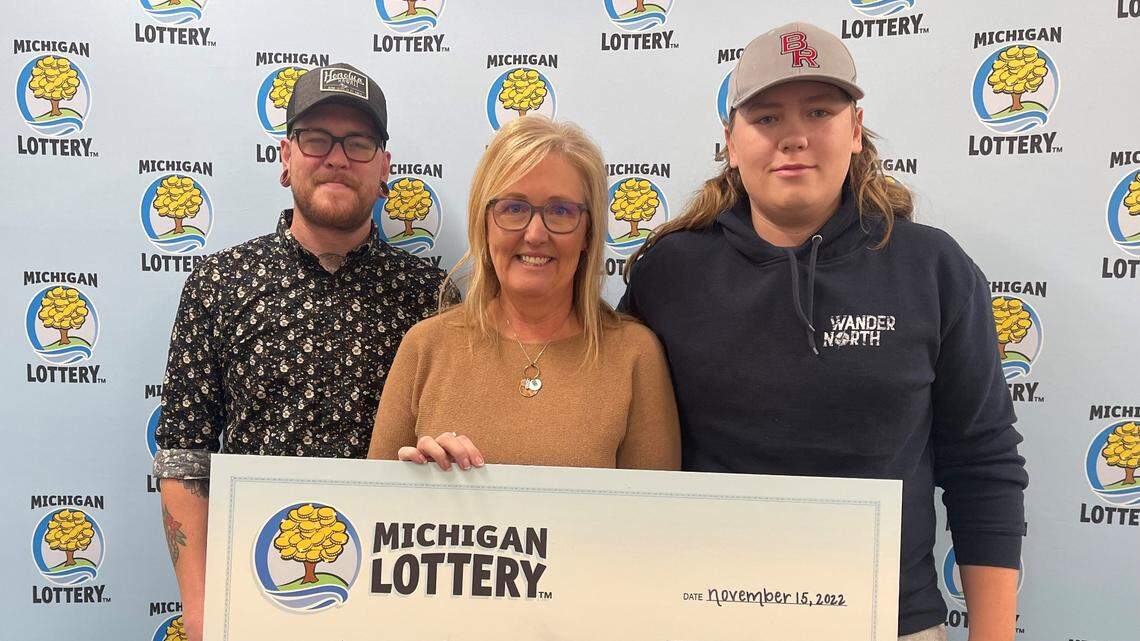Joni Thompson, center, won $1 million her first time ever playing the Powerball, Michigan Lottery officials say.