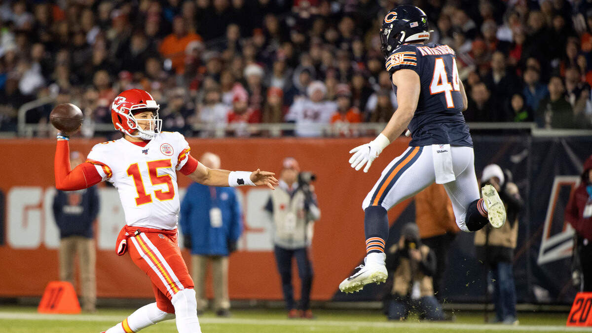 Kansas City Chiefs quarterback Patrick Mahomes (15) rushes the ball against Chicago Bears linebacker Nick Kwiatkoski (44) during the first half at Soldier Field.