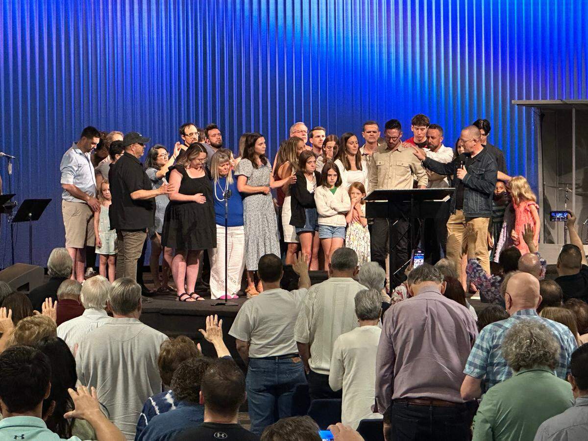 Members of the International House of Prayer-Kansas City’s Forerunner Church worship team gathered to pray with senior pastor Isaac Bennett on May 19, 2024, as the church held its final service in Grandview. IHOPKC has been in turmoil since its founder, Mike Bickle, was accused last year of sexually abusing multiple women.