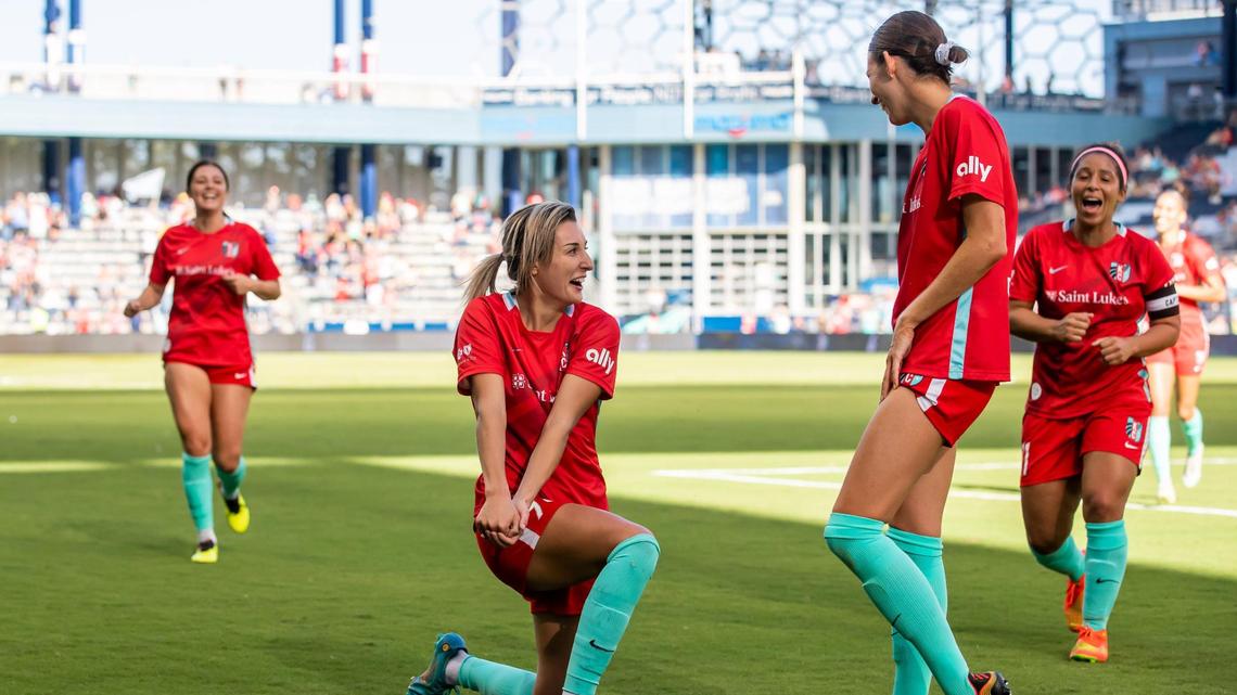 KC Current midfielder Claire Lavogez, on one knee after scoring a goal, celebrates her strike against the Washington Spirit on Sunday at Children’s Mercy Park in Kansas City, Kansas.