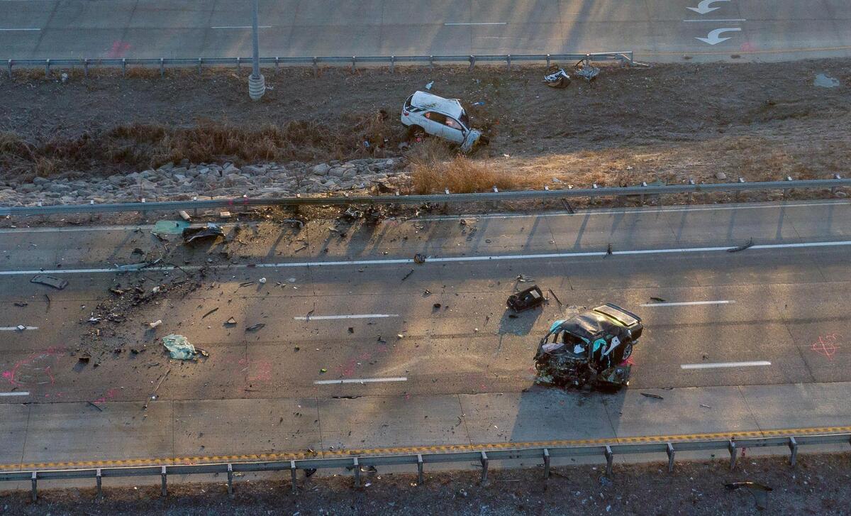 Kansas City police work the scene of a fatal crash on Interstate 435 near Missouri Highway 210 on Tuesday, Jan. 2, 2024, in Kansas City. Two people died after a vehicle being chased by police was headed the wrong way on I-435 and crashed head-on into another vehicle.