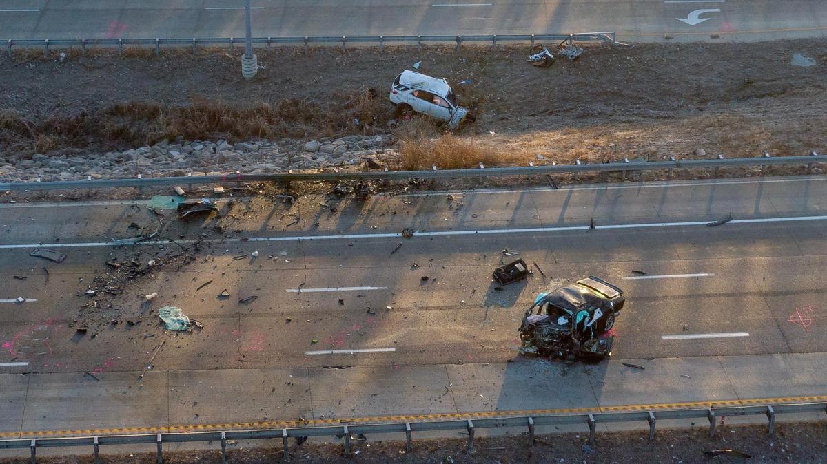 Kansas City police work the scene of a fatal crash on Interstate 435 near Missouri 210 highway on Tuesday, Jan. 2, 2024, in Kansas City. Two people died after a vehicle being chased by police was headed the wrong way on I-435 and crashed head-on into another vehicle.