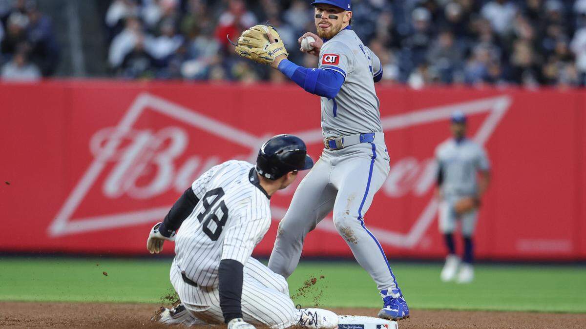 Kansas City Royals shortstop Bobby Witt Jr. attempts to throw past New York baserunner Paul Goldschmidt on a first-inning play at second base during a Wednesday, April 16, 2025 Major League Baseball game at Yankee Stadium.