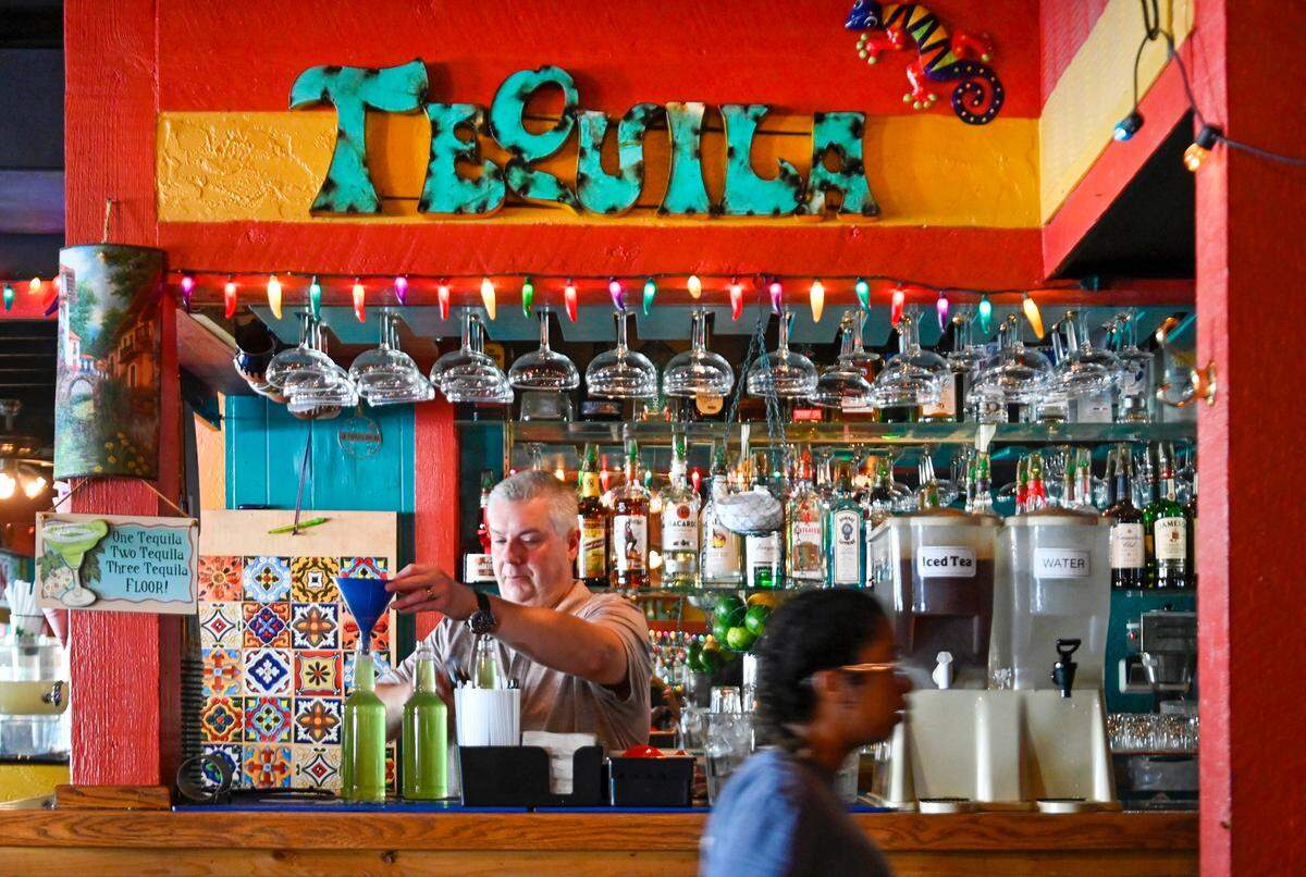 Brice Shockley, bartender and manager at Torreon Mexican Restaurant, fills bottles with house-made margaritas for carryout. His grandparents founded the restaurant in 1960.