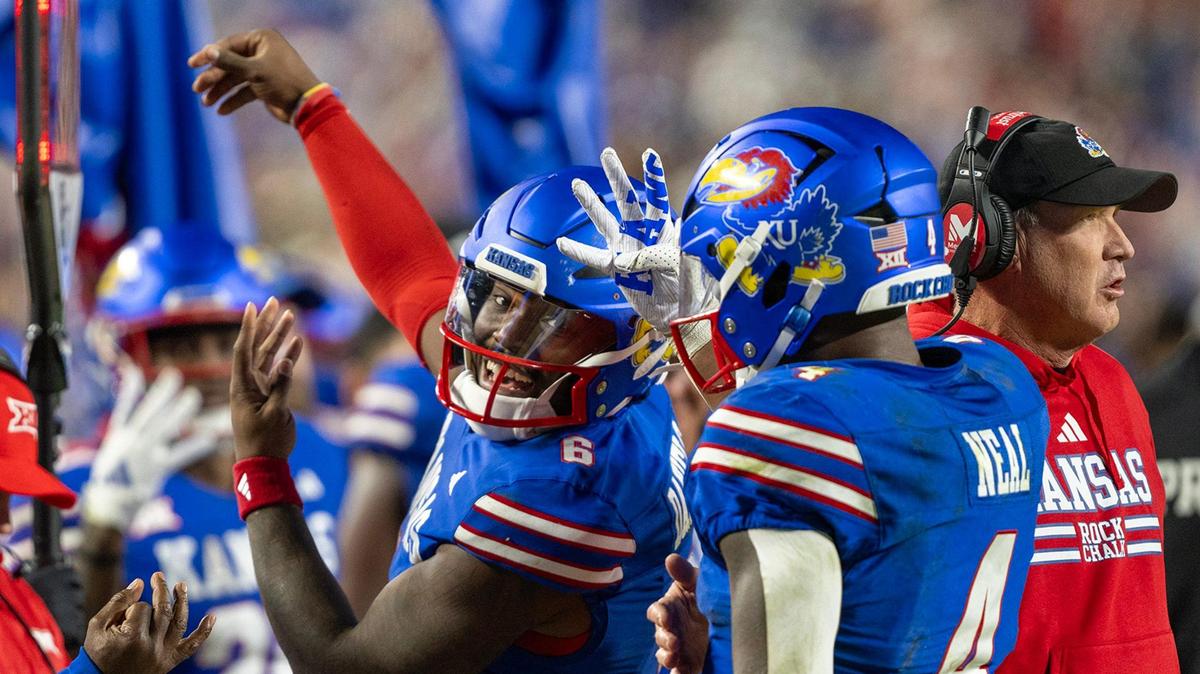 Kansas Jayhawks quarterback Jalon Daniels (6) and running back Devin Neal (4) celebrate late in the second half after Neal scored his fourth touchdown of the game at GEHA Field at Arrowhead Stadium on Saturday, Nov. 23, 2024, in Kansas City.