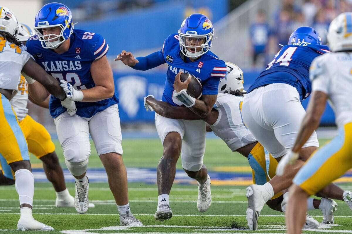 Kansas Jayhawks quarterback Isaiah Marshall (8) runs through a tackle in the first half of the Jayhawks game vs. Long Island University Sharks at David Booth Memorial Stadium on Friday, September 4, 2026, in Lawrence.