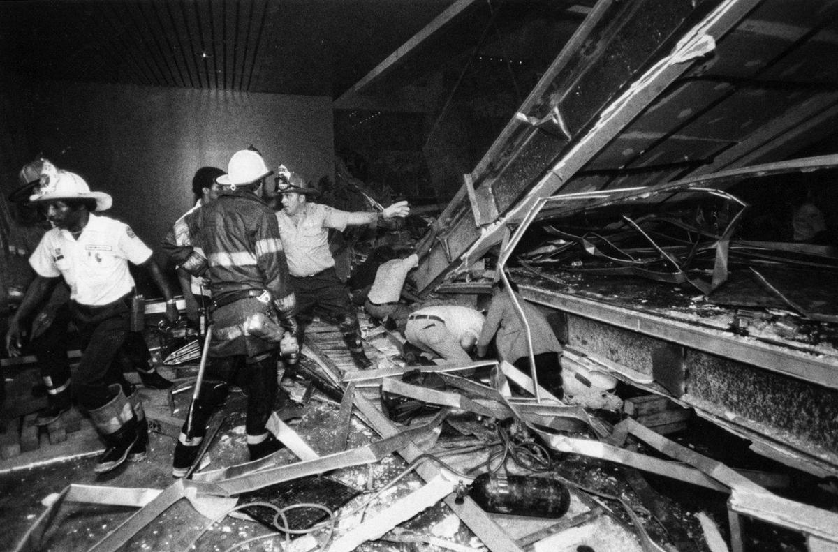 Firefighters urgently worked to free survivors trapped under the collapsed skywalks at the Hyatt Regency.