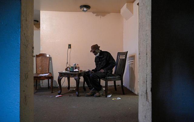 Joe Amrine checks messages as he gets ready for work Wednesday, Oct. 27, 2021. This day is his 65th birthday, which means he is eligible for Medicare. Amrine spent 17 years on death row and was exonerated in 2003. Without job skills or being eligible for benefits, he has struggled.