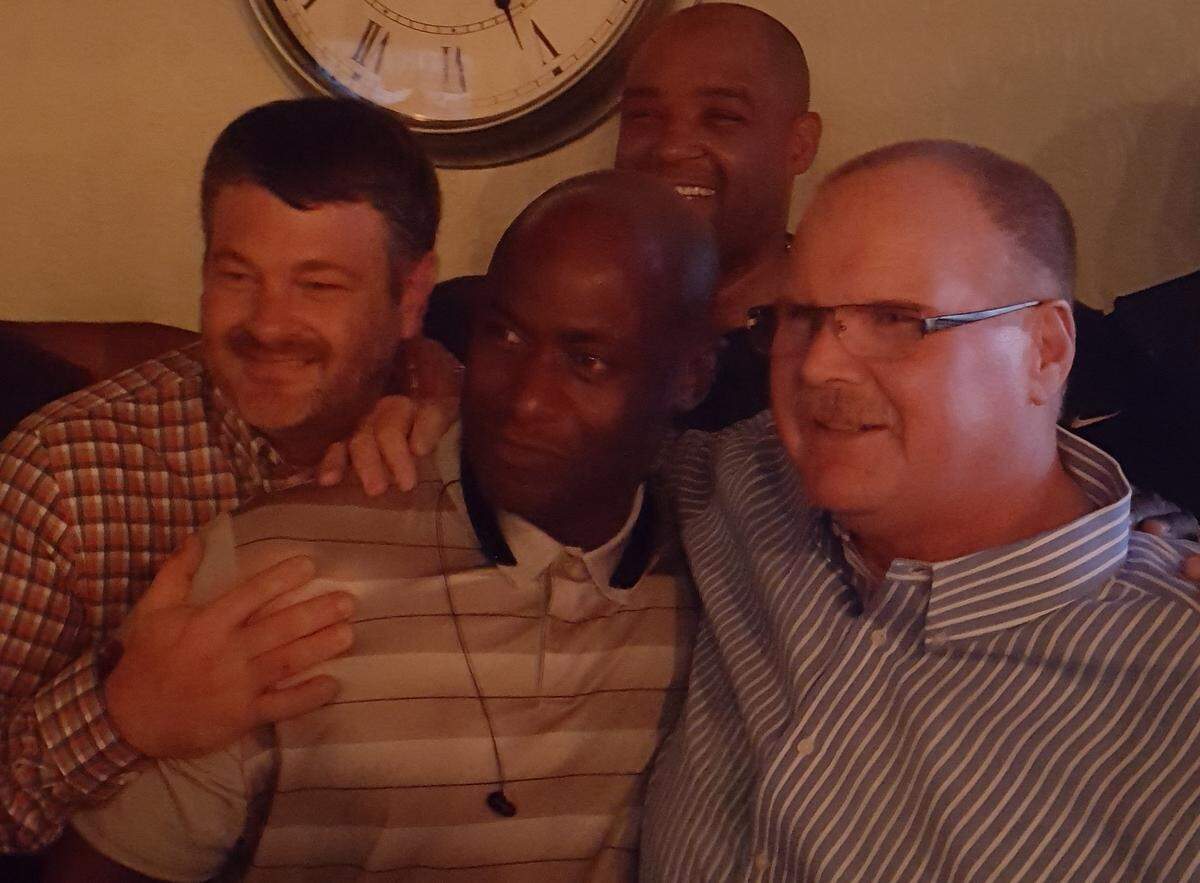 From left, Phil Johnson, Travis McDonald and Steve Martin with Andy Reid.