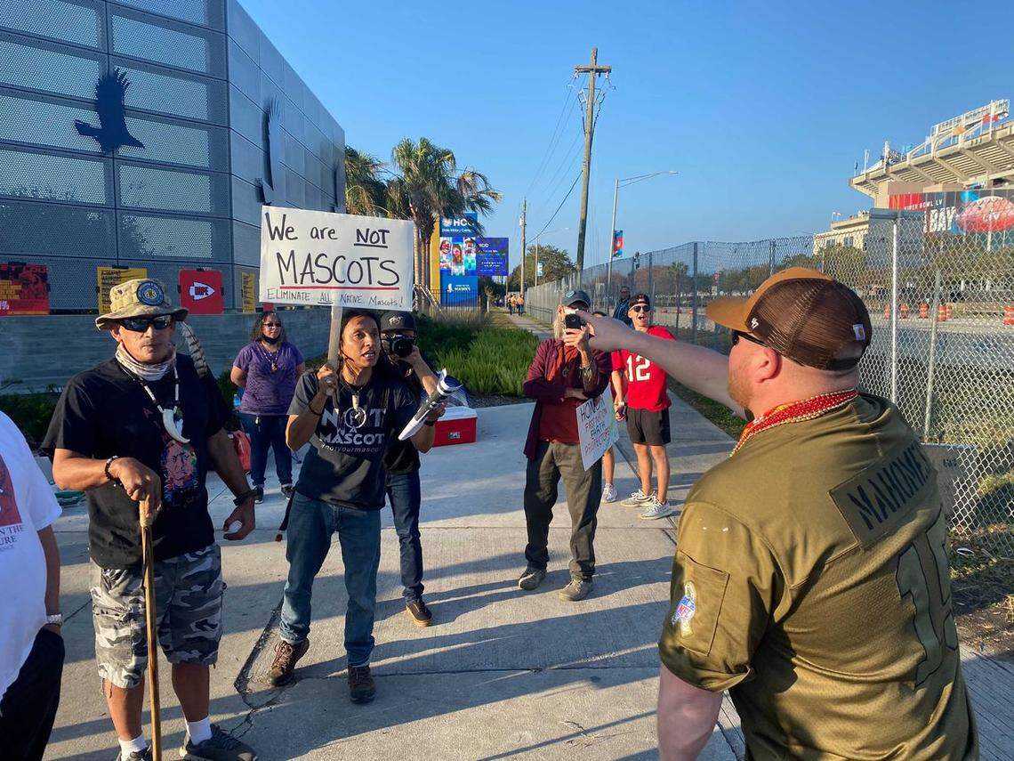 Stuart Flores of local activist group FIREE (Florida Indigenous Rights and Environmental Equality) gets into a heated exchange with a Kansas City Chiefs fan outside of Raymond James Stadium over the team’s use of Native American imagery.