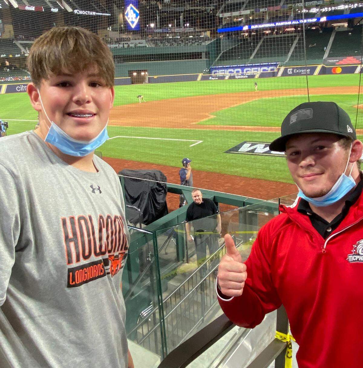 Because of COVID, this is the only way umpire Todd Tichenor (in background) was able to see his kids after the pinnacle of his career. Son Kooper is on the left, Kaden on the right.