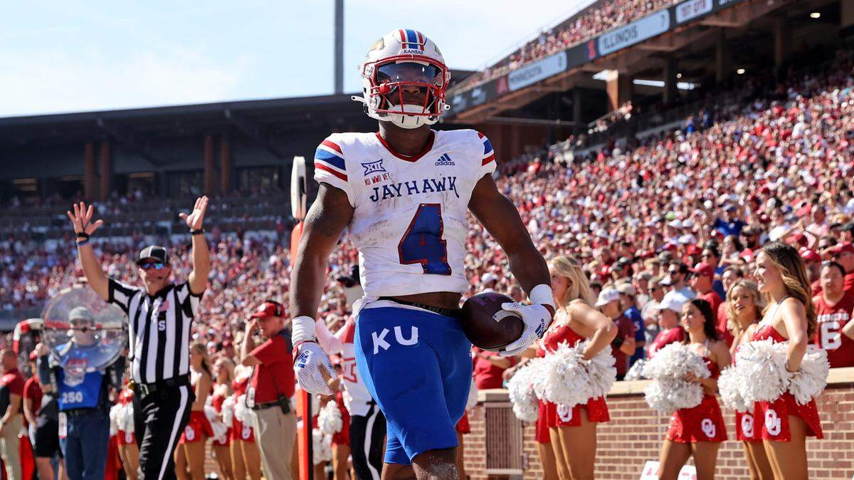Kansas Jayhawks running back Devin Neal (4) reacts after scoring a touchdown during the first half against the Oklahoma Sooners at Gaylord Family-Oklahoma Memorial Stadium on Oct. 15, 2022.