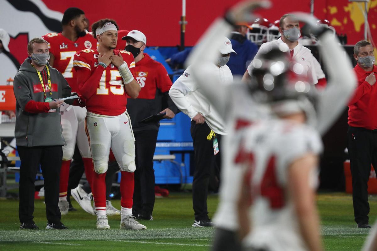 Kansas City Chiefs quarterback Patrick Mahomes watches from the sidelines while the Tampa Bay Buccaneers celebrate their victory Sunday, February 7, 2021, at Super Bowl LV at Raymond James Stadium in Tampa, Florida.