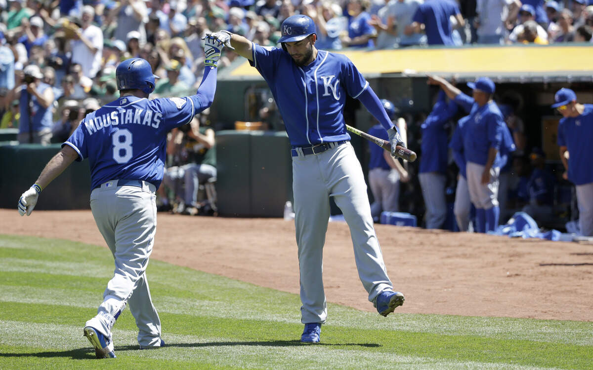 Kansas City Royals' Mike Moustakas (8) celebrates his solo home run with teammate Eric Hosmer during the third inning of a baseball game, Sunday, April 17, 2016, in Oakland, Calif. 