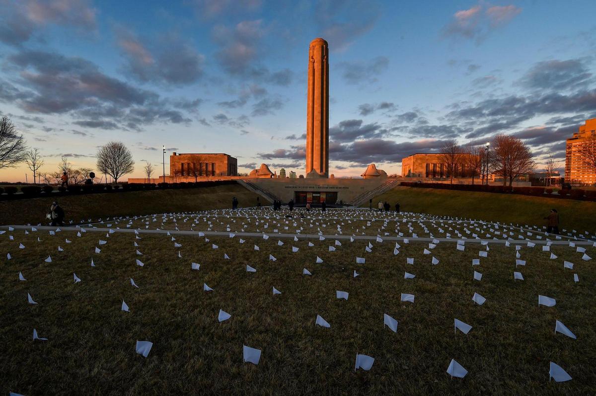 People who lost their lives to COVID-19 were remembered and frontline workers were honored on the National Day of Remembrance Tuesday, Jan. 19, 2021. A white flag for each of the 1,665 people who died of COVID in the Kansas City metro area was planted in front of the National World War I Museum and Memorial and the city skyline was lit in amber. This coincided with ceremonies across the country.