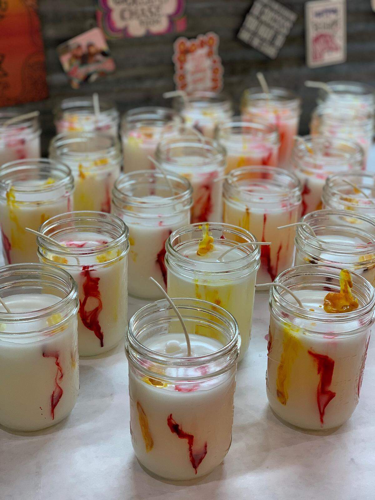 The KC Pride candle — white with swirls of red and gold and white with sparkle.