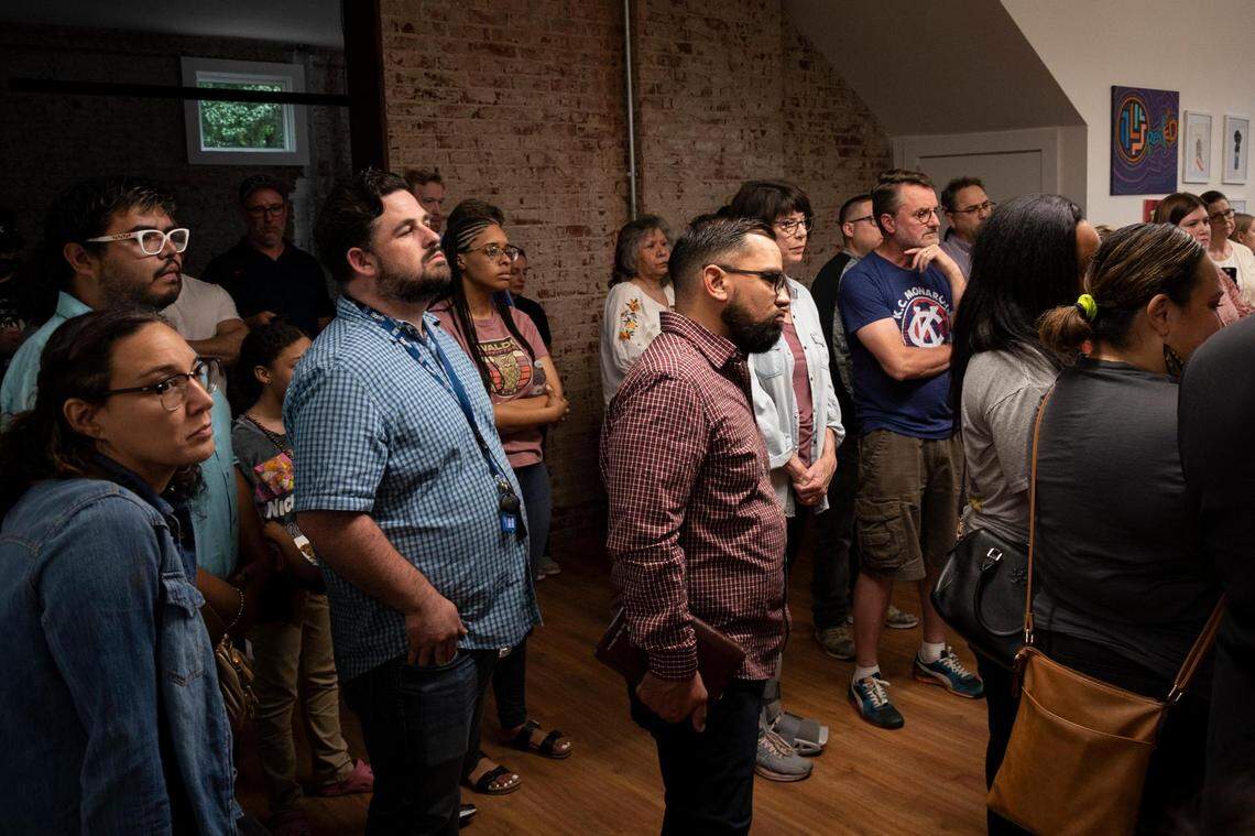 Late in the evening, people gather at the Latinx Education Collaborative for the “Vigilia para nuestros niños” (Vigil for Our Children), in Kansas City on May 31, 2022.