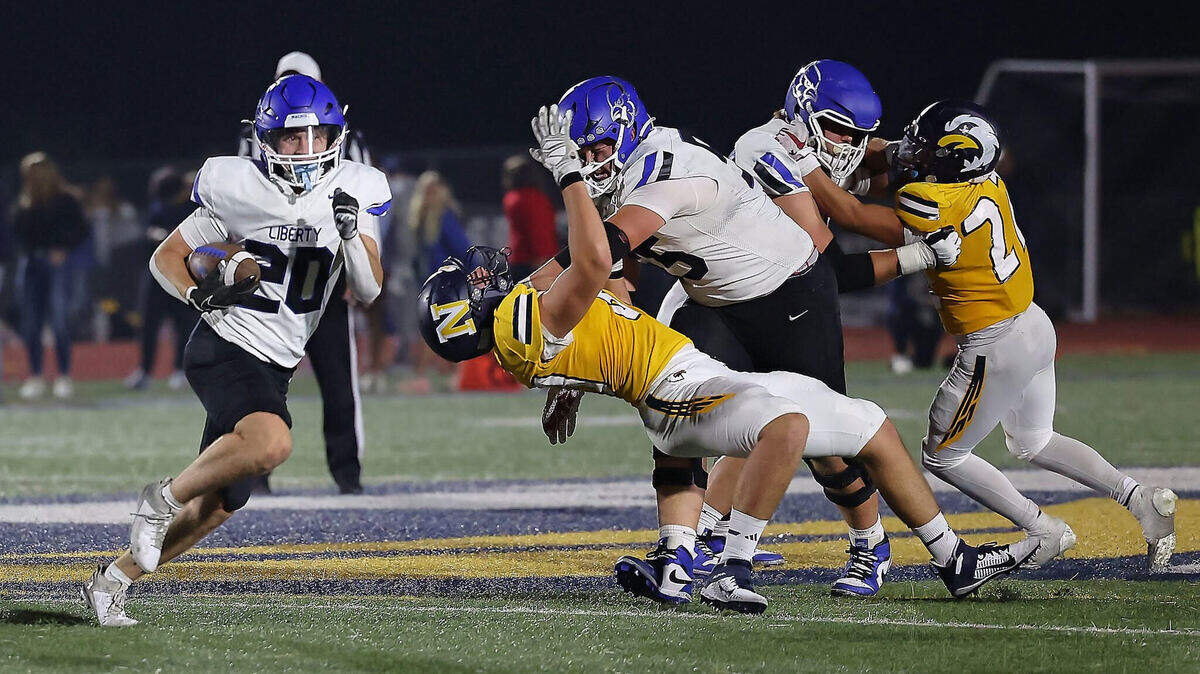 Tailback Colt Nolin (No. 20, at left) and offensive linemen Jonathan Pearcy (55) and Brooks Lawson (78) helped Liberty rack up 245 rushing yards in a 38-22 win over Liberty North on Friday night.