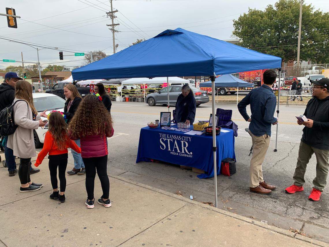Star staff distribute free naloxone, a medicine that reverses opioid overdoses, and resource guides alongside partners from DCCCA at the Dia de Muertos festival along Central Avenue in Kansas City, Kansas.