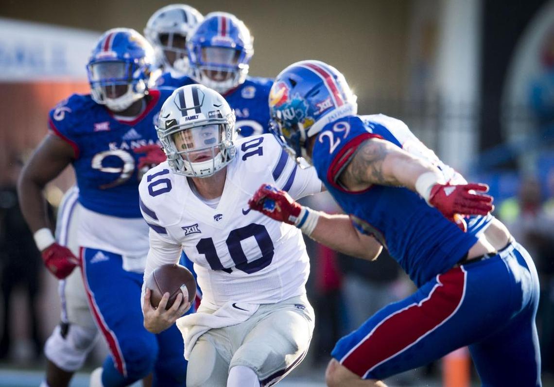 Kansas State Wildcats quarterback Skylar Thompson (10) stopped to shift direction as Kansas Jayhawks linebacker Joe Dineen Jr. (29) pursued in the fourth quarter during the University of Kansas and Kansas State University Big 12 football game at the University of Kansas in Memorial Stadium on Oct. 28, 2017, in Lawrence.