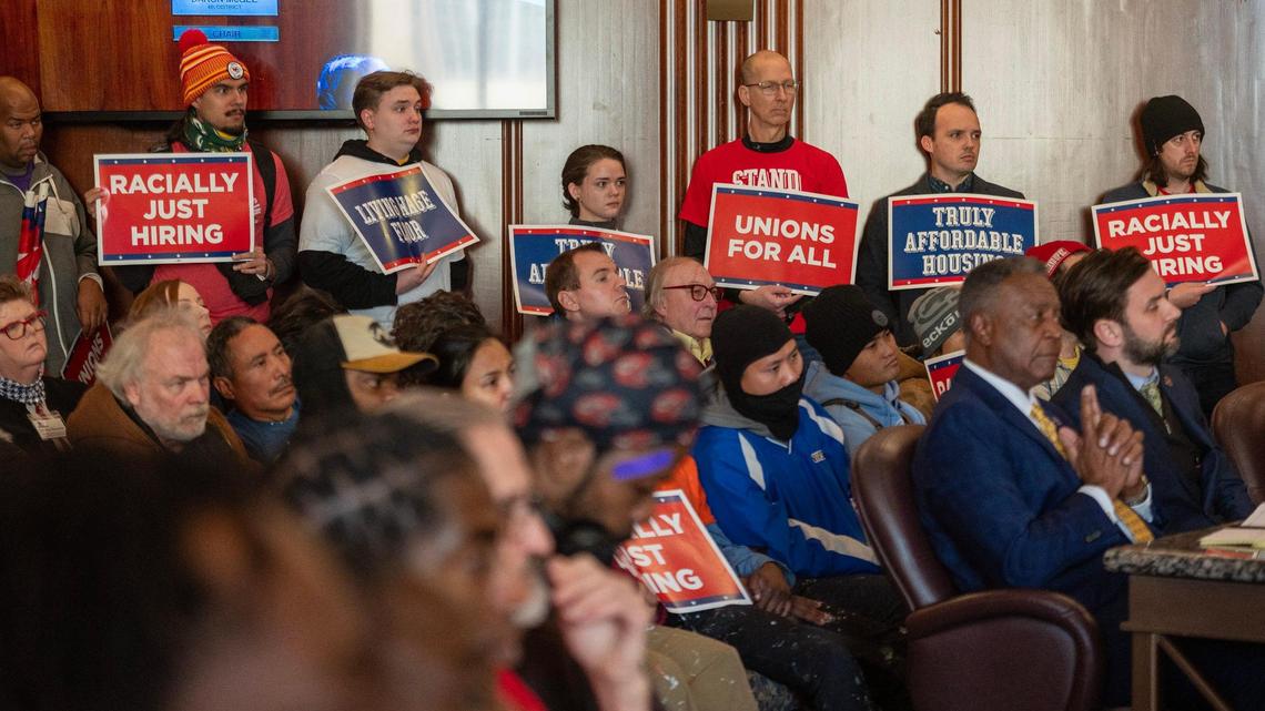Community members hold up signs during legislature meeting at the Jackson County Courthouse on Monday, Dec. 18, 2023, in Kansas City. Low-wage workers objected to public funding for a new Royals stadium without a strong Community Benefits Agreement ensuring living-wage jobs and affordable housing.