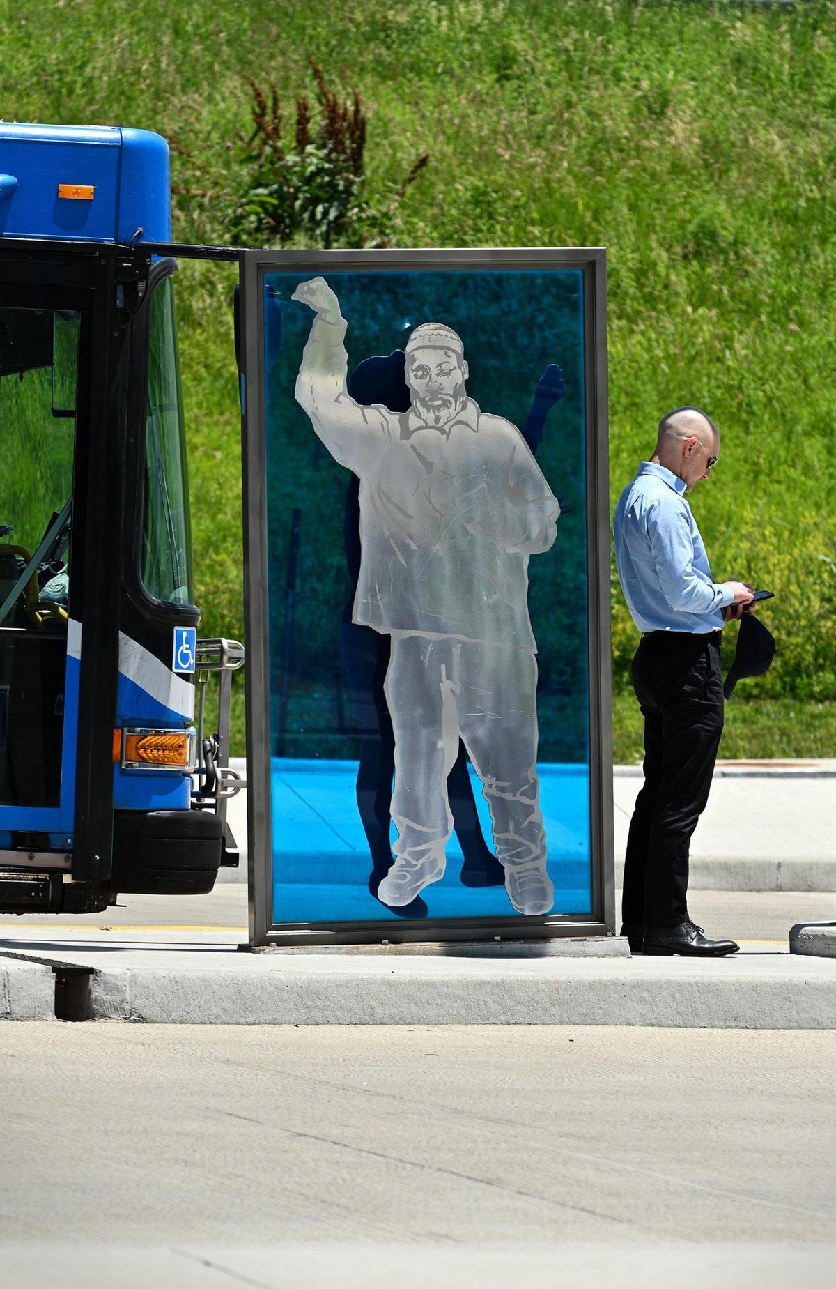 A man pauses outside a bus after it drops passengers off at the East Village Transit Center at 12th and Charlotte streets Monday, June 6, 2022.