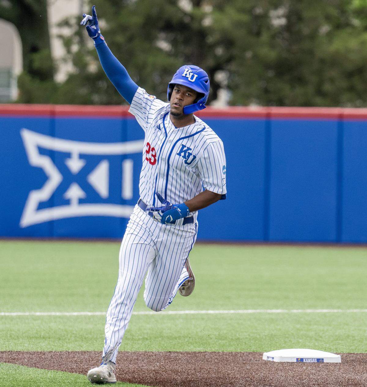 Kansas Jayhawks infielder Dariel Osoria (23) runs the bases after hitting a home run against the Northeastern Huskies in the third inning of an NCAA baseball tournament game at Hoglund Ballpark on Friday, May 29, 2026, in Lawrence.