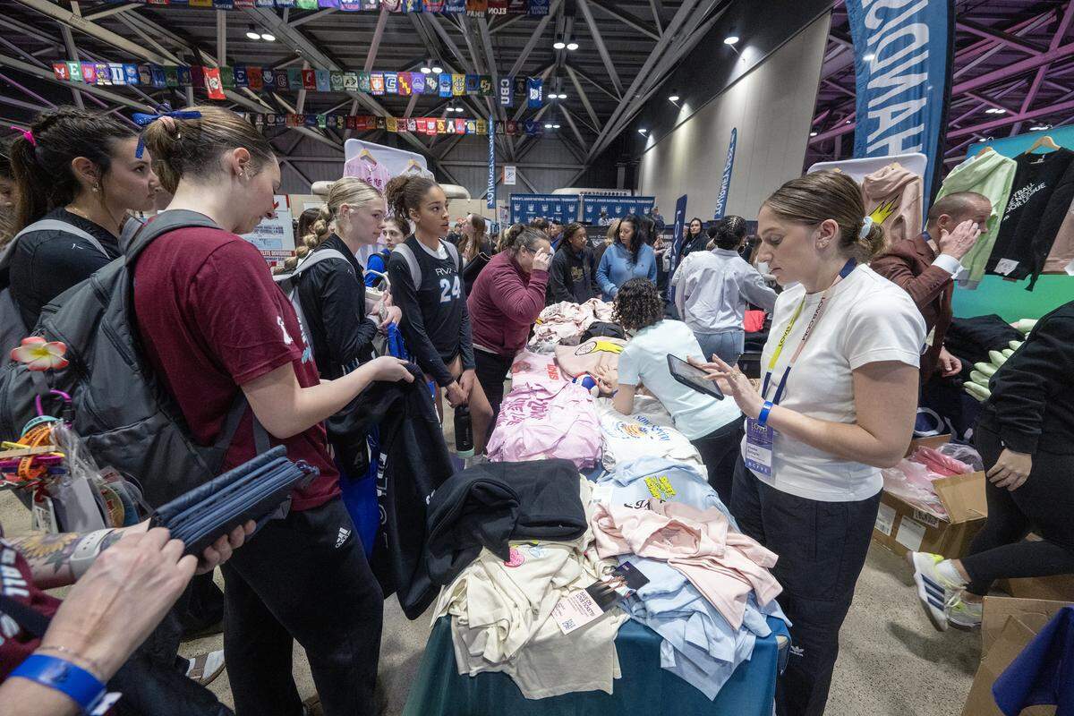 A vendor selling volleyball shirts was packed with players and guests at The&nbsp;Triple Crown NIT on Sunday, February 15, 2026 at Bartle Hall at the&nbsp;Kansas City Convention Center. 