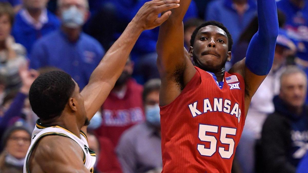 KU’s Jalen Coleman-Lands (right) elevates over George Mason’s Xavier Johnson for a three-pointer during the second half of Saturday’s game at Allen Fieldhouse (Jan. 1, 2022).