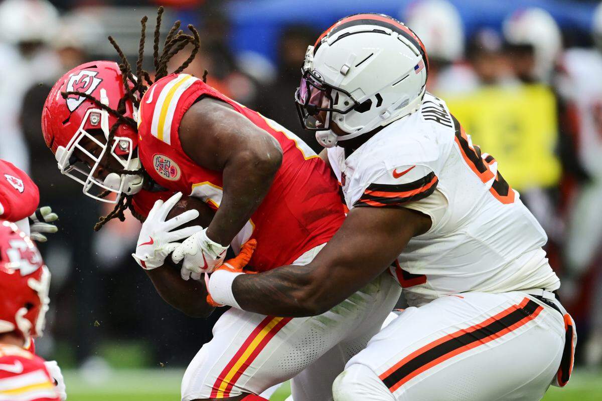 Kansas City Chiefs running back Kareem Hunt carries Cleveland Browns defensive tackle Mike Hall Jr. for some extra yardage during an NFL Week 15 game at Huntington Bank Field in Cleveland, Ohio on Sunday, Dec. 15, 2024.