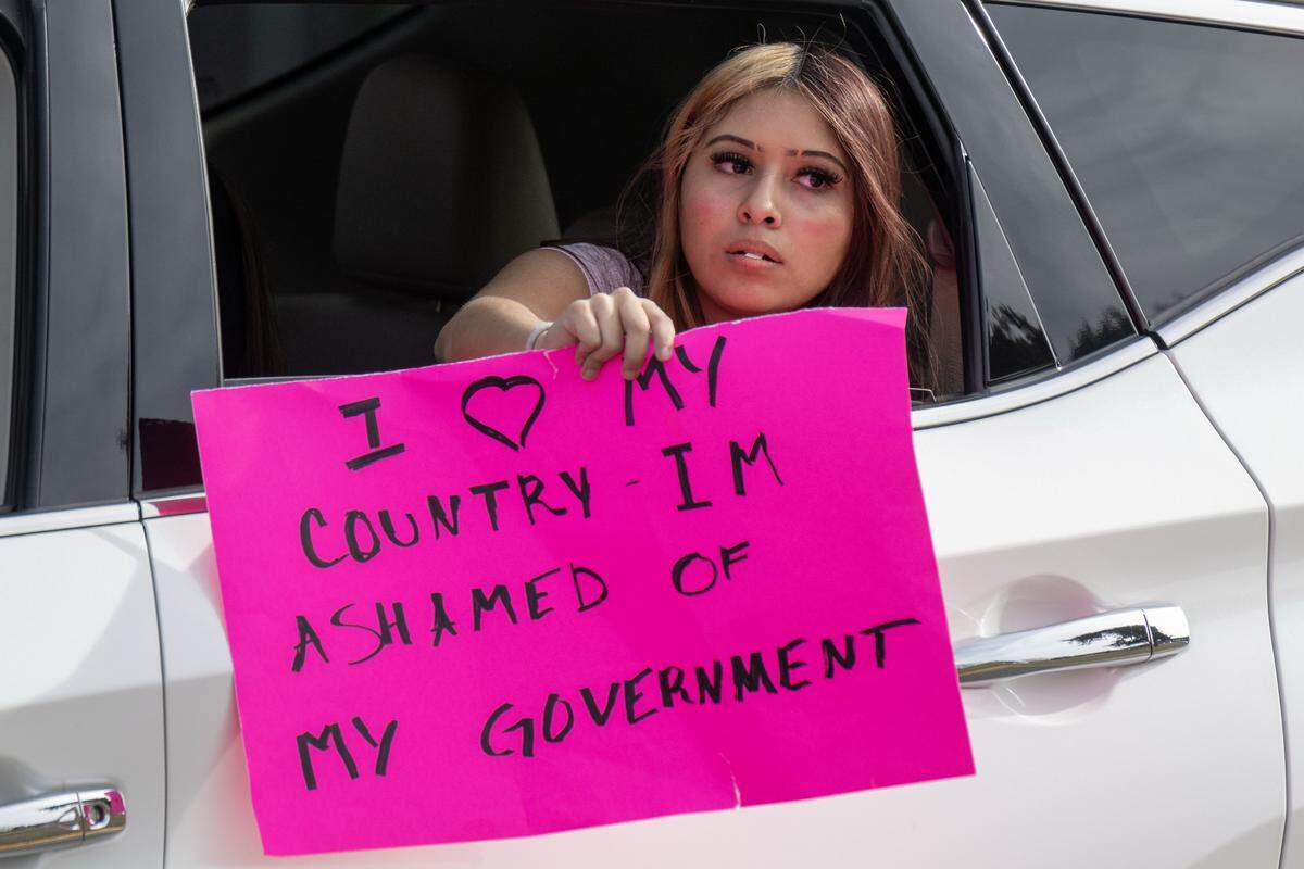 A student at Shawnee Mission North High School holds a sign from a vehicle during a protest of ICE and the Trump administration's policies on Wednesday, February 11, 2026, in Overland Park.
