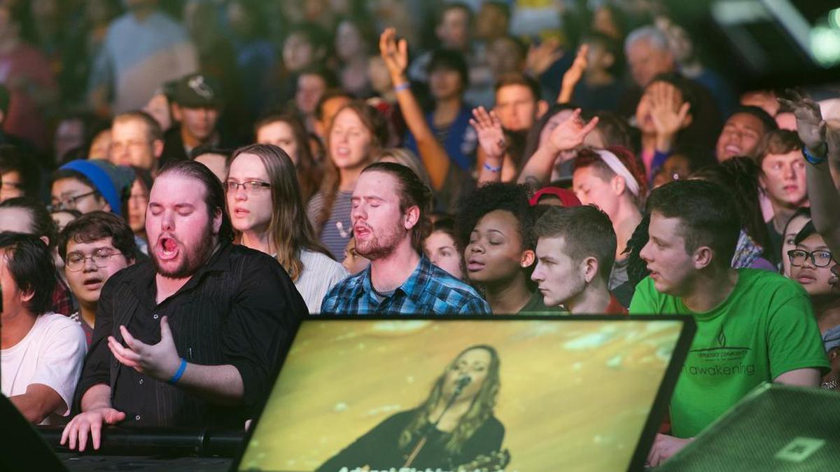 Rachel Faagutu (pictured on screen) sang for thousands who joined the afternoon worship Tuesday during the Onething Conference, which was organized by the International House of Prayer and held at Bartle Exhibit Hall in Kansas City.