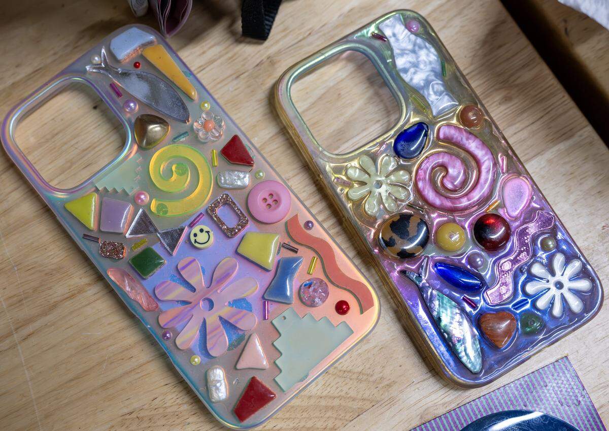 Phone cases designed by artist Paulina Otero are seen on a desk at her studio on Tuesday, March 3, 2026, in Kansas City.