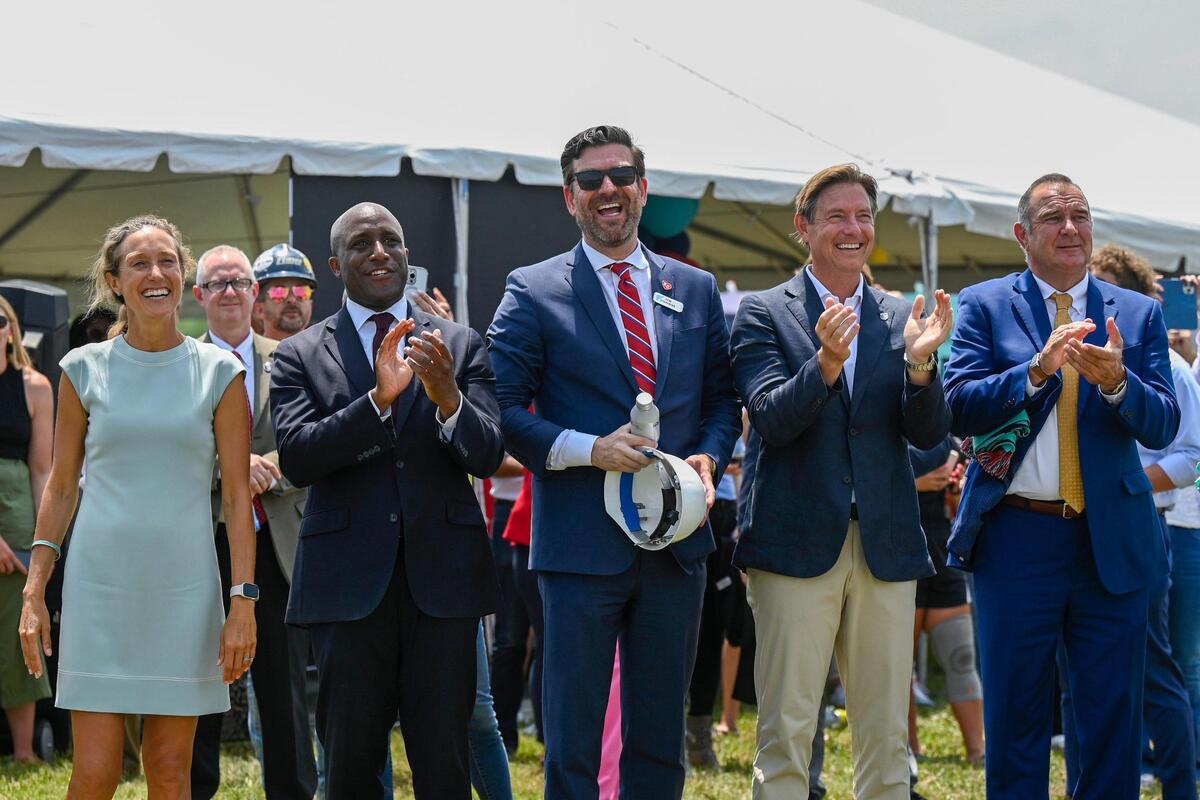 Kansas City Current co-owner Angie Long, from left, Mayor Quinton Lucas and Jon Stephens, President & CEO at Port KC, Kansas City Current co-owner Chris Long, and Missouri Lieutenant Governor Mike Kehoe applauded and watched as the final beam was hoisted into place at the new KC Current stadium under construction Wednesday, June 21, 2023, at Berkley Riverfront Park in Kansas City.
