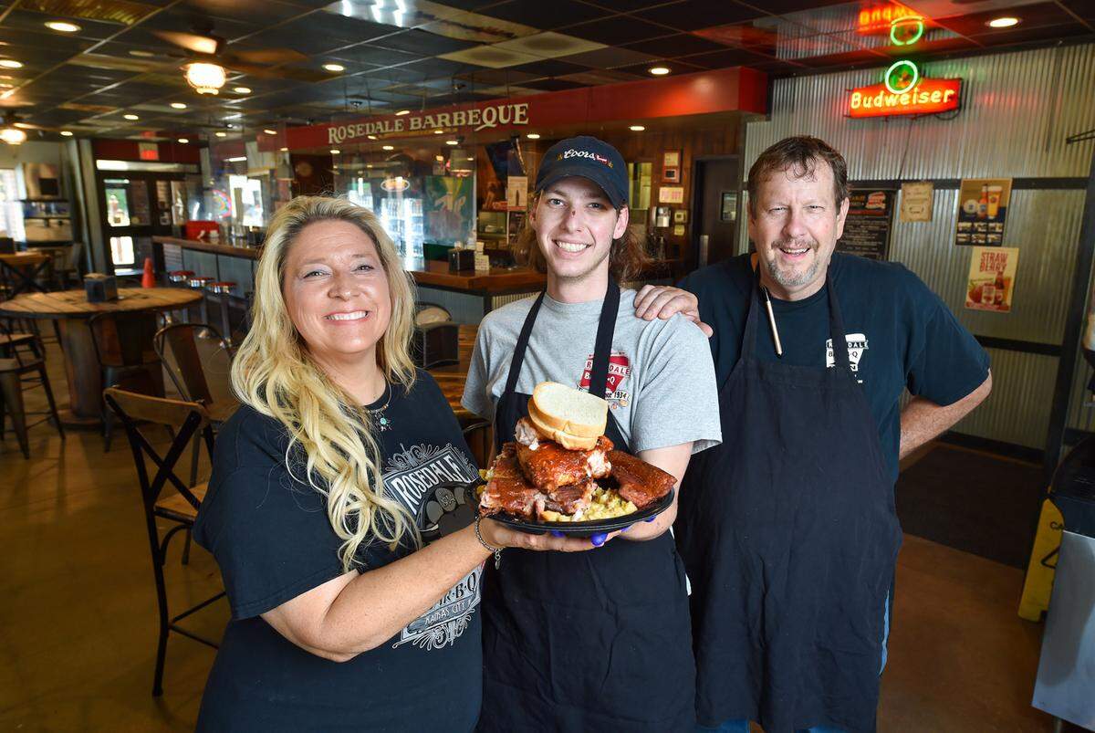 Marisha Brown-Smith, husband Bill Smith, right, and their son, Cole Smith, 19, can be found running Rosedale Bar-B-Q six days a week. The restaurant, which dates to 1934, has always been family owned and operated.