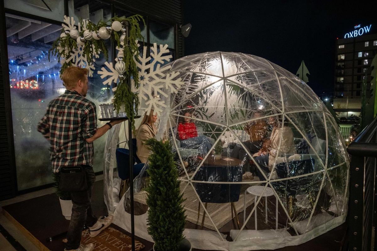 Chicken N Pickle’s North Kansas City pop-up is fashioned to look like a ski lodge with igloos, Christmas trees and outdoor fire pits.