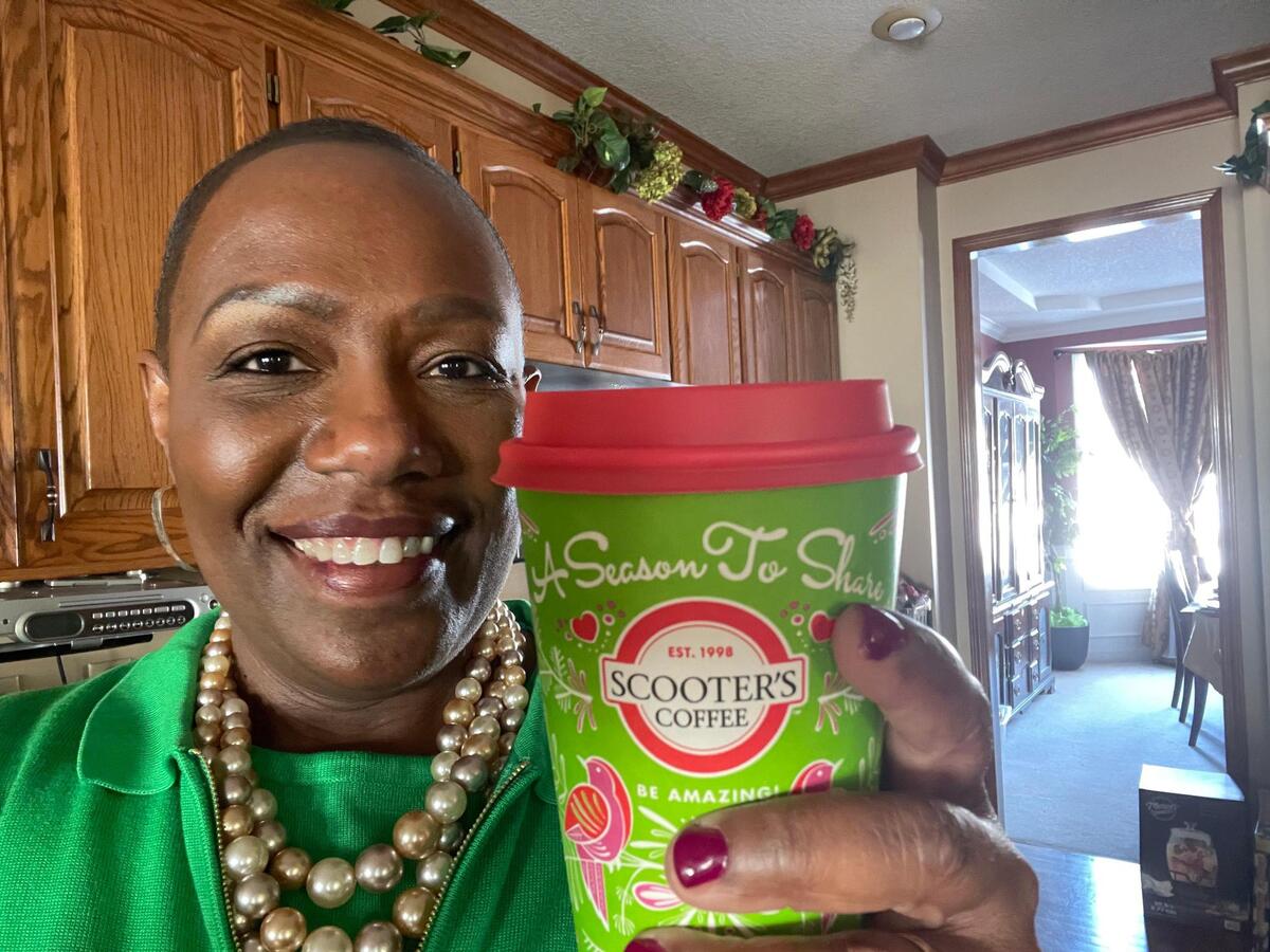 Linessa Frazier enjoying a cup of coffee at home.