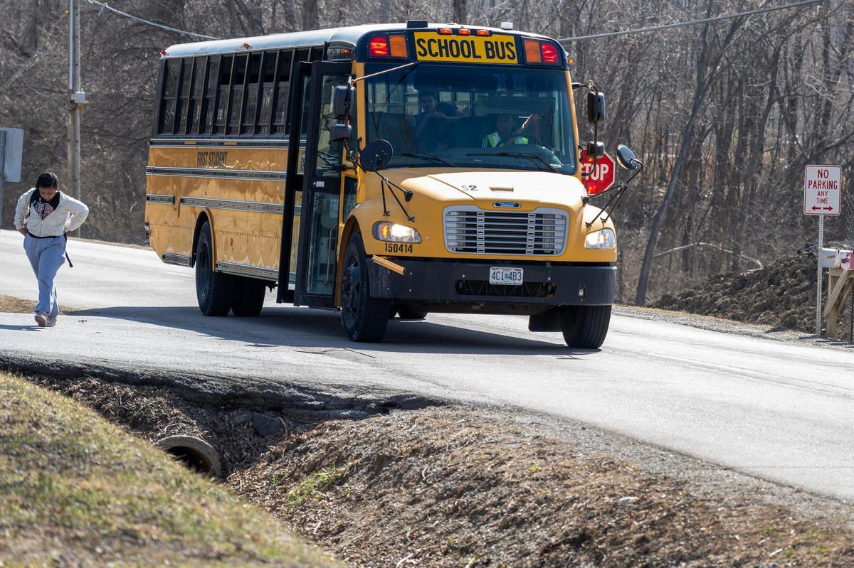 A school bus drops off students at a stop along North West Waukomis Drive on Wednesday, March 12, 2025, in Northmoor.