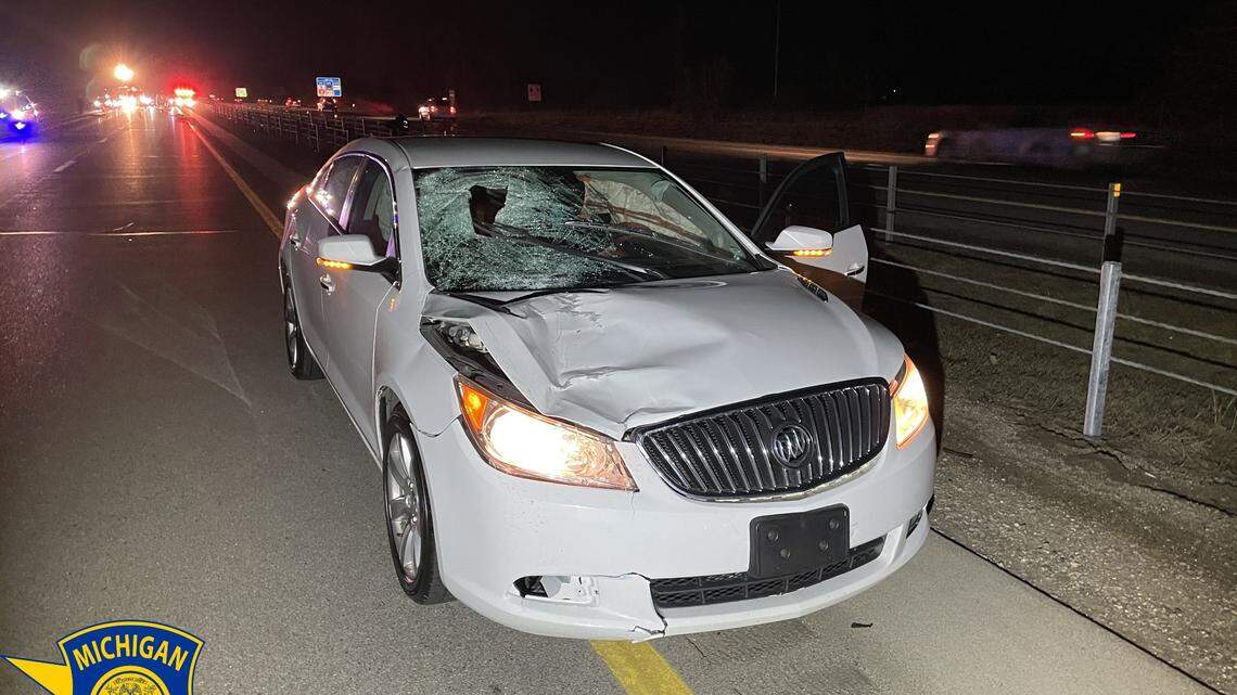 A 44-year-old driving a white Buick Lacrosse hit a 72-year-old woman getting out of her car on the highway, Michigan cops say.