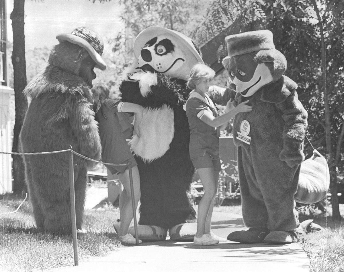 Teens suited up in animal costumes before greeting patrons at the Worlds of Fun opening.