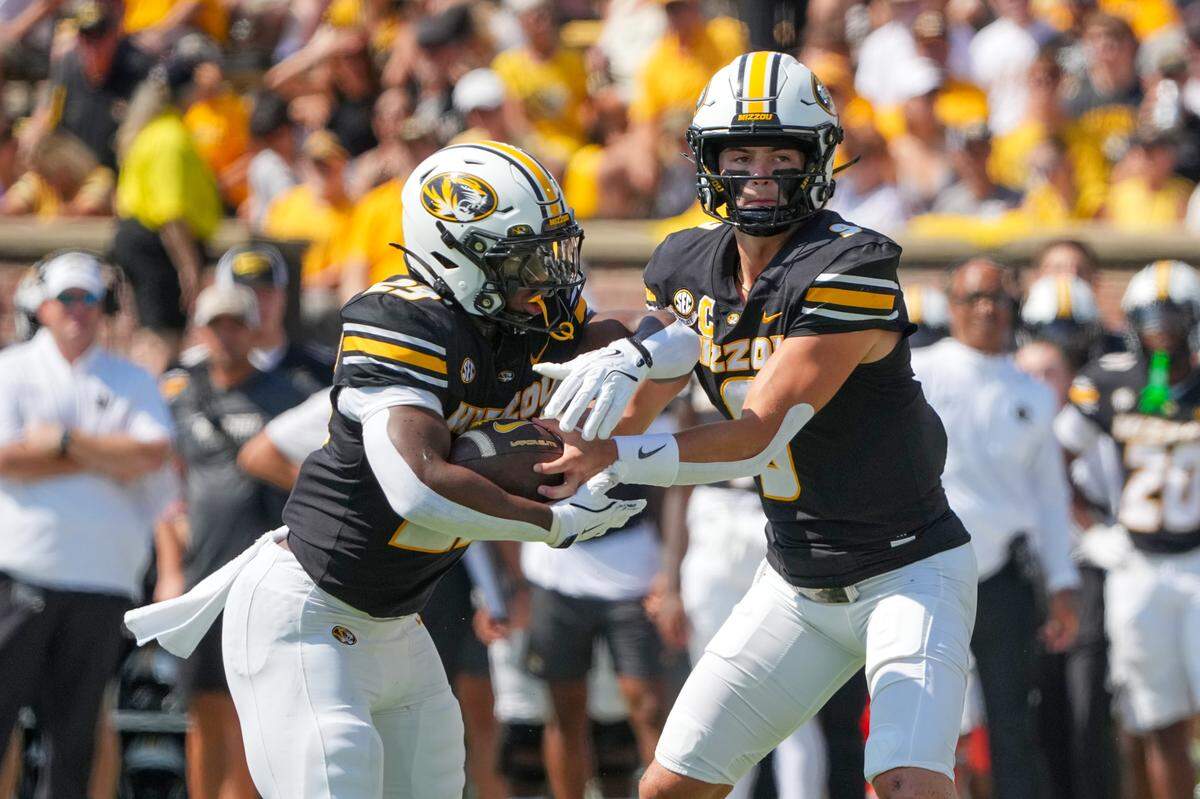 Missouri Tigers quarterback Beau Pribula (9) hands off to running back Ahmad Hardy (29) against the Louisiana Ragin’ Cajuns during the first half at Faurot Field at Memorial Stadium on Sept. 13, 2025.