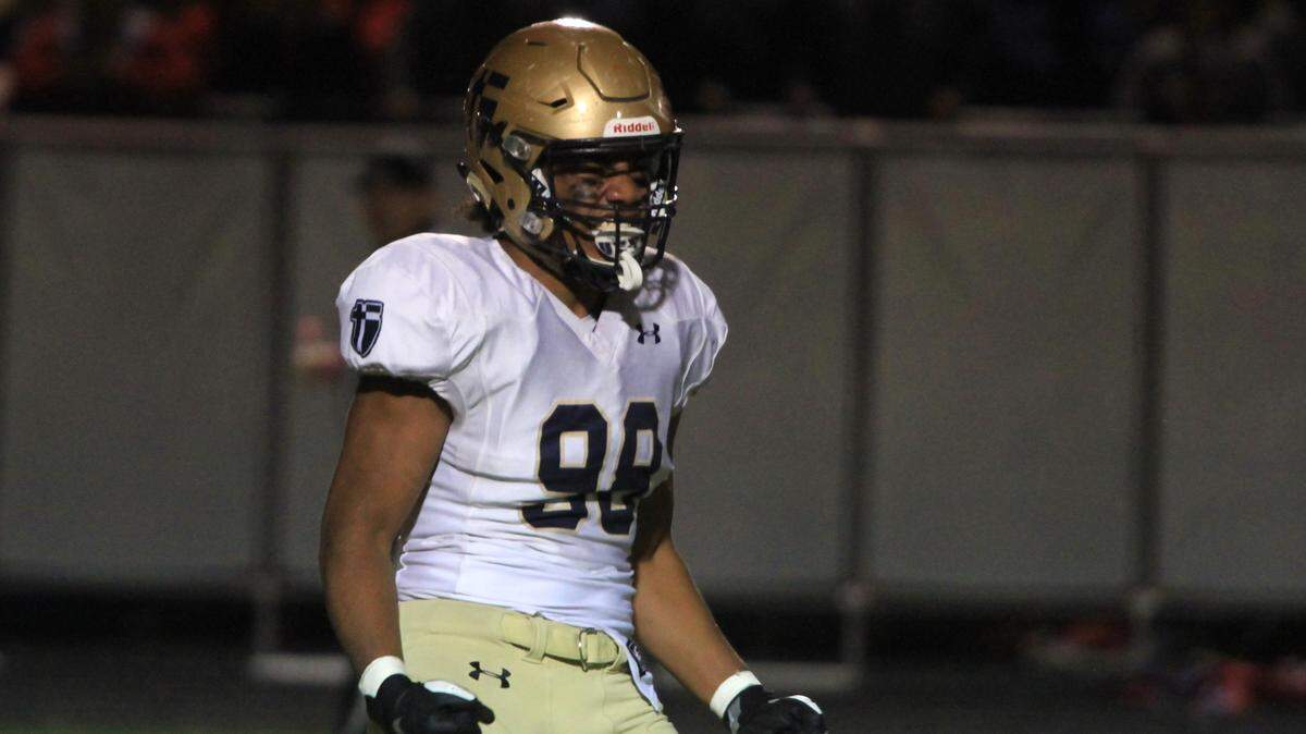 St. Thomas Aquinas defensive end Sa’o Siavi’i celebrates a sack of Bishop Miege quarterback Timothy Dorsey in Friday night’s game at Dixon Doll Stadium.