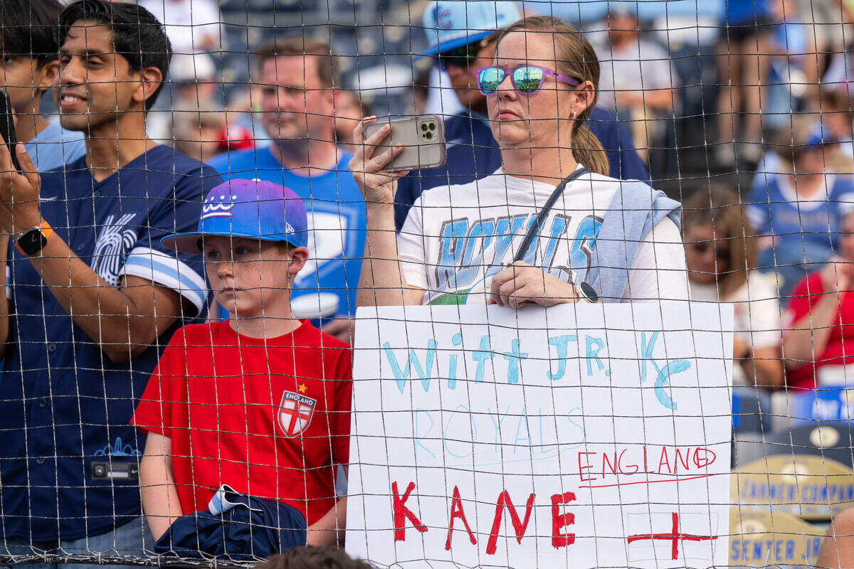 A fan holds a sign for England soccer star Harry Kane and the Royals’ Bobby Witt Jr. before KC’s game against the St. Louis Cardinals at Kauffman Stadium in Kansas City on Thursday, June 18, 2026.