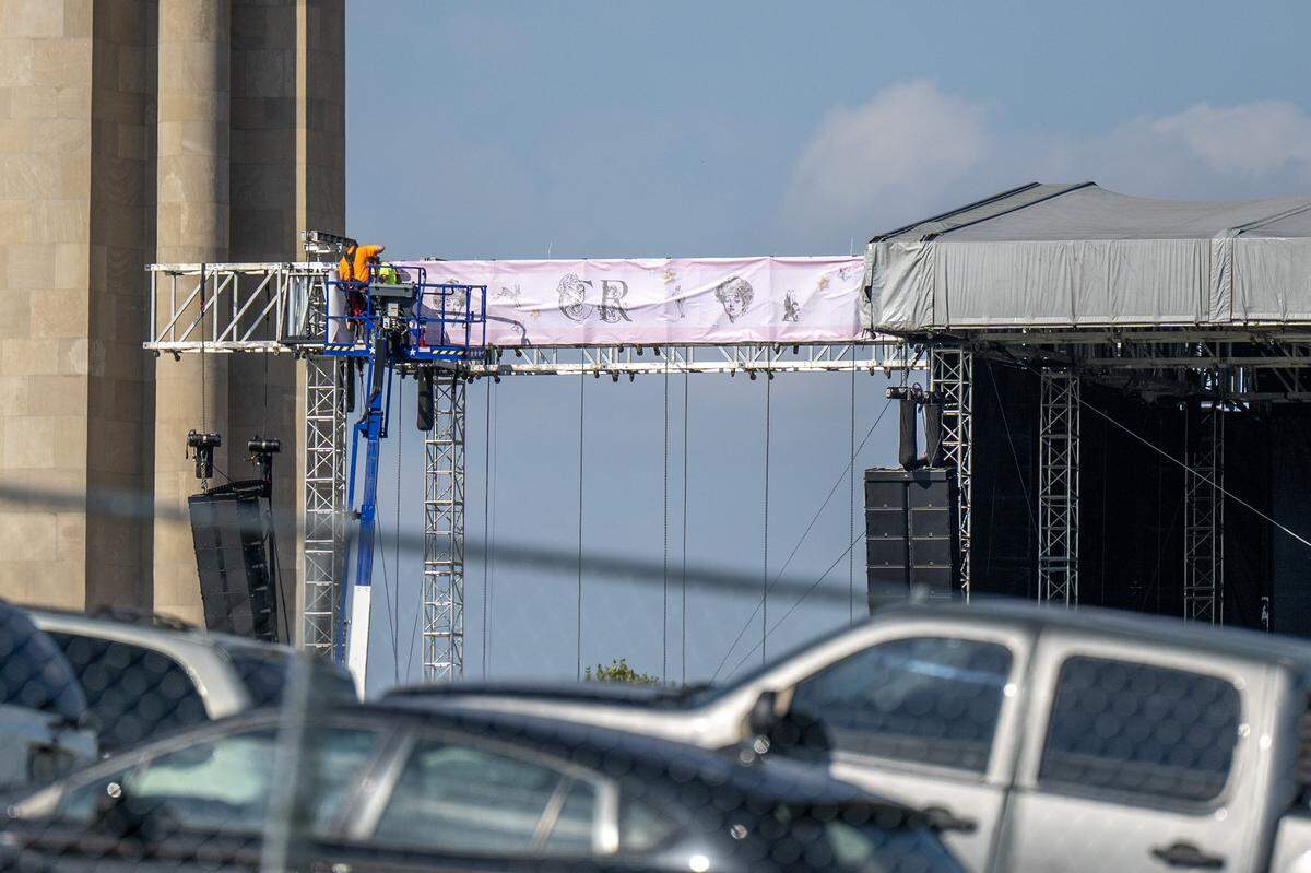 Event staffers set up banners onto a stage outside the National WWI Museum and Memorial on Wednesday, Oct. 1, 2025, in Kansas City, ahead of pop singer Chappell Roan's concert Visions of Damsels and Other Dangerous Things.