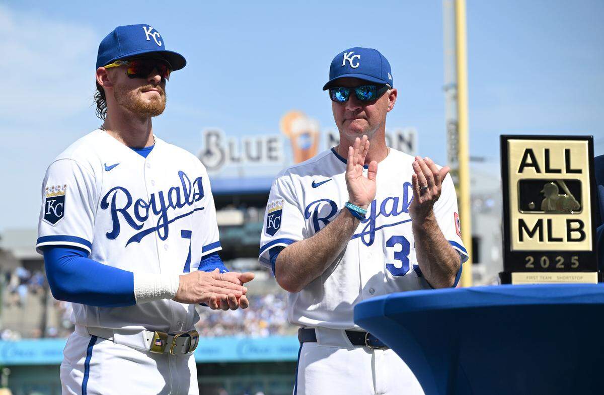 Kansas City Royals shortstop Bobby Witt Jr. (7) and manager Matt Quatraro clap during an award ceremony before the home opener against the Minnesota Twins on Monday, March 30, 2026, in Kansas City.