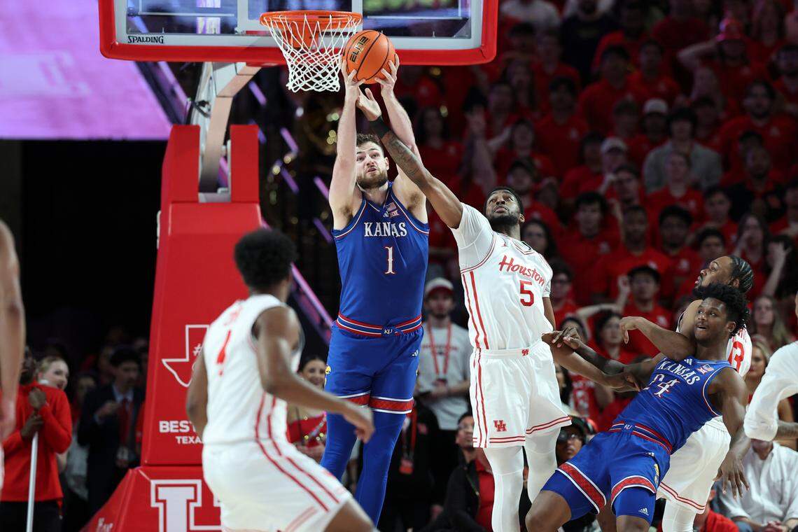 Kansas Jayhawks center Hunter Dickinson (No. 1) and Houston Cougars forward Ja’Vier Francis (No. 5) battle for possession during a Big 12 college basketball game at the Fertitta Center in Houston on Monday, March 3, 2025.