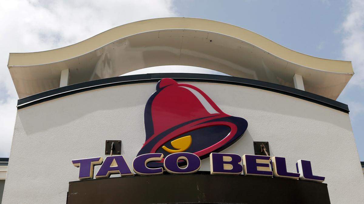 FILE- This Aug. 3, 2017, file photo shows a Taco Bell sign at a restaurant in Hialeah, Fla. Yum Brands, Inc., which operates Taco Bell, KFC and Pizza Hut reports earnings Wednesday, Oct. 31, 2018. (AP Photo/Alan Diaz, File)