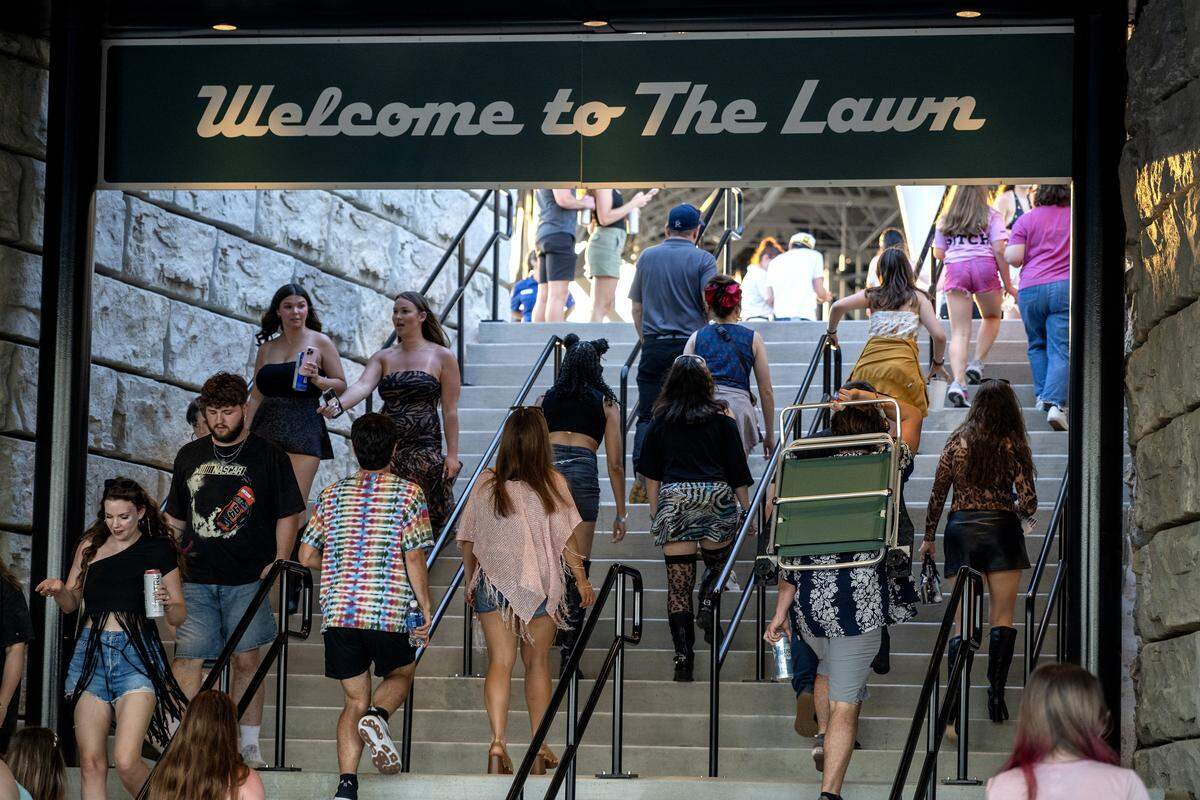 People walk up steps to get to the lawn seating area at Morton Amphitheater on Wednesday, June 3, 2026, in Riverside.