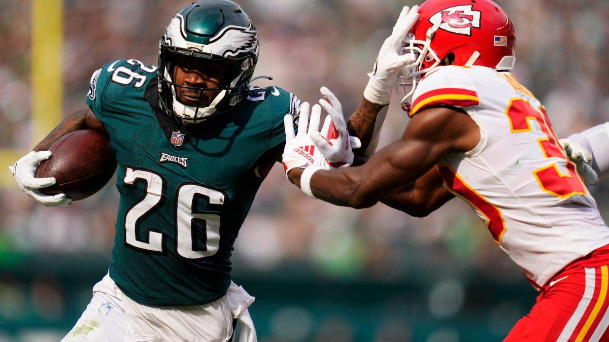 Philadelphia Eagles running back Miles Sanders (26) runs past Kansas City Chiefs cornerback Deandre Baker (30) during the second half of an NFL football game Sunday, Oct. 3, 2021, in Philadelphia. (AP Photo/Matt Slocum)