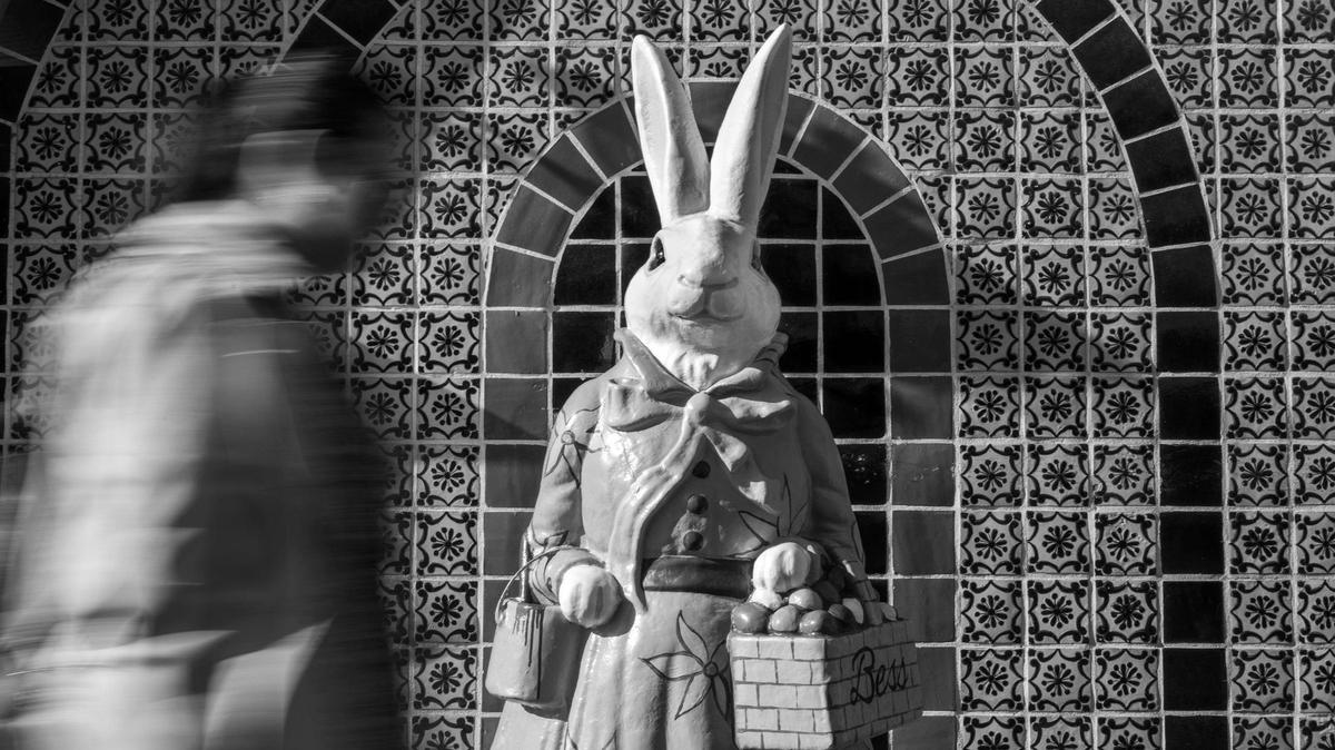 Pedestrians stroll past an Easter bunny sculpture named Bess along West 47th Street at the Country Club Plaza on Monday, April 14, 2025.